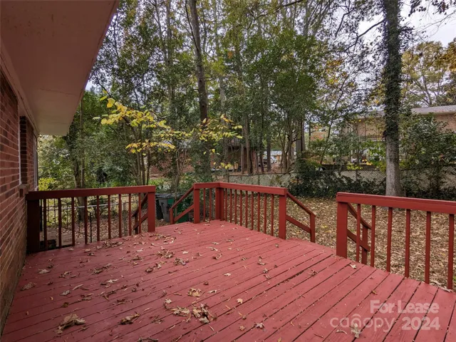 Large deck overlooks fenced-in back yard