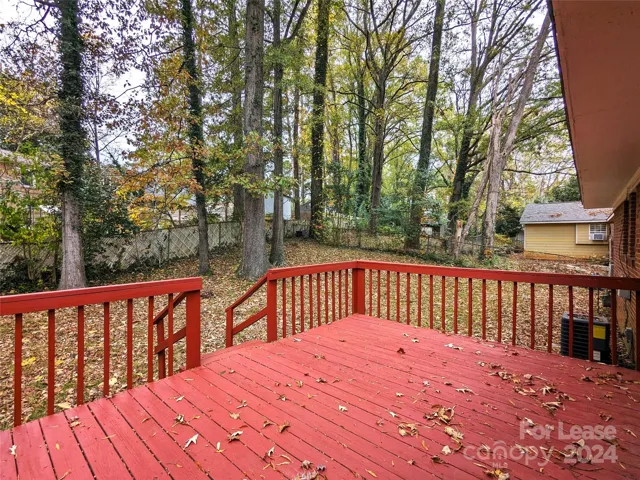 Large deck overlooks fenced-in back yard