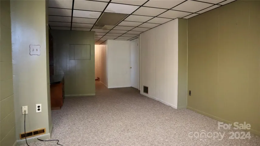 Looking into office area in basement leading to the upstairs
