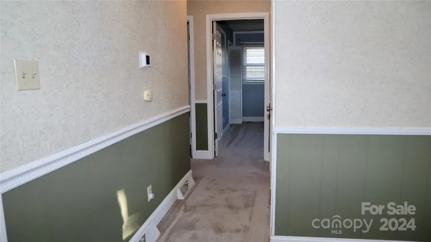 Hall leading to bedrooms and upstairs bath