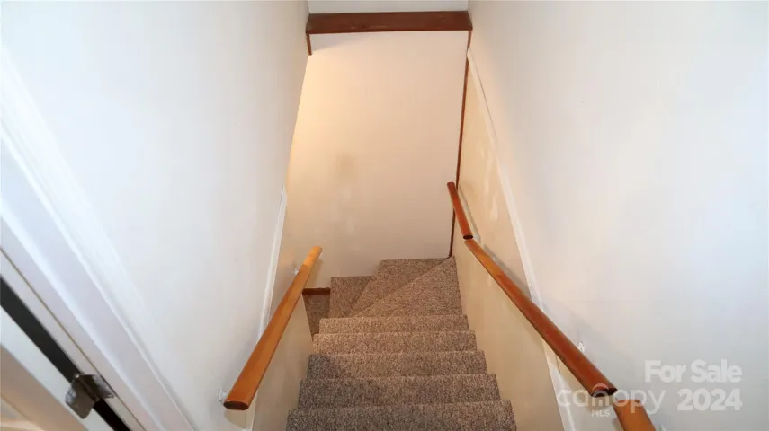 Entrance to basement stairs off of kitchen
