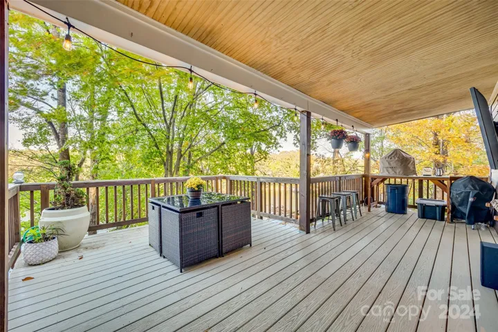 This home boasts an expansive outdoor deck, ideal for hosting gatherings or simply enjoying the serene lake views.