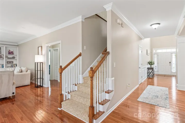 Guest suite entrance and laundry to your left. Now, let's head upstairs....