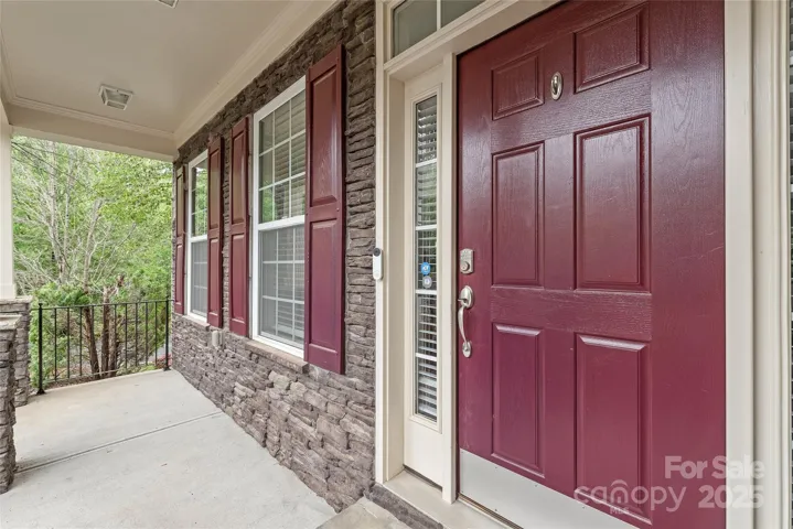 Step up to your door under this covered front porch.