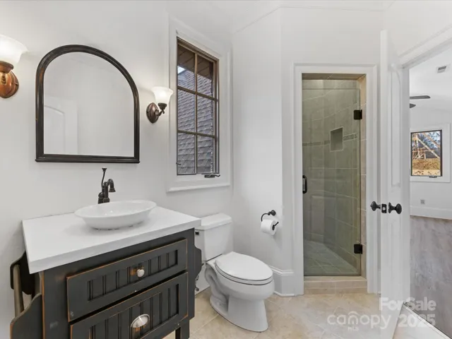 Guest Bathroom with neutral tile floors and shower surround