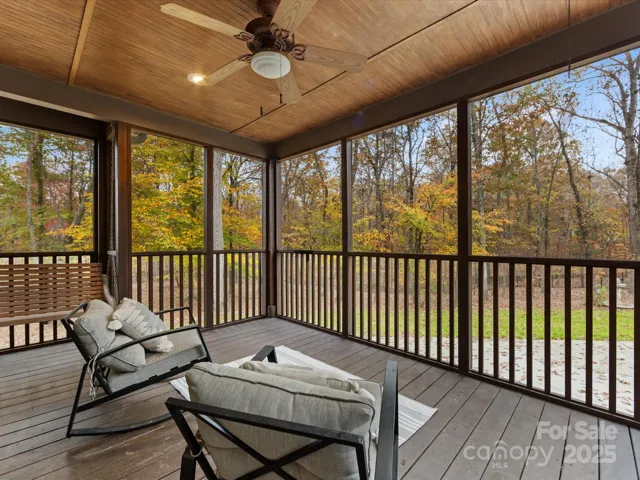 Screened Porch with charming swing and view of the wooded backyard