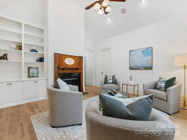 Front Sitting Room or Office with glass entry, doors, vaulted ceiling, fireplace and wet bar off Primary Suite