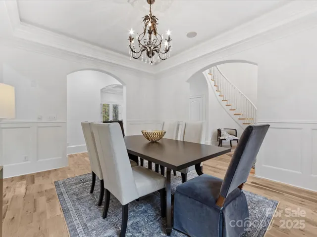 Dining Room with wainscoting, tray ceiling, uplighting and Butler's Pantry