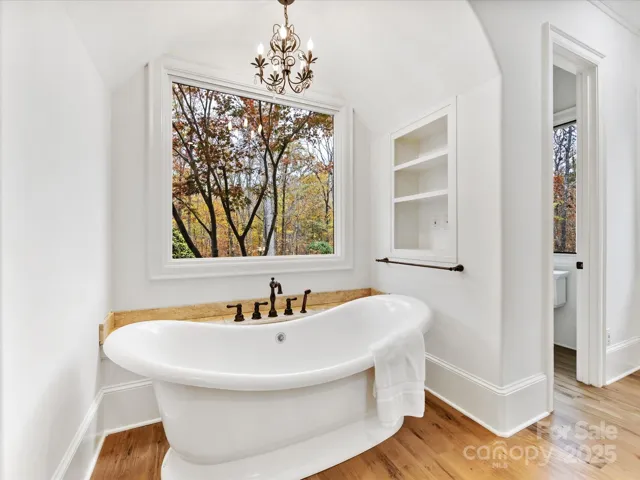 Primary Bath with freestanding tub and curved archway detail