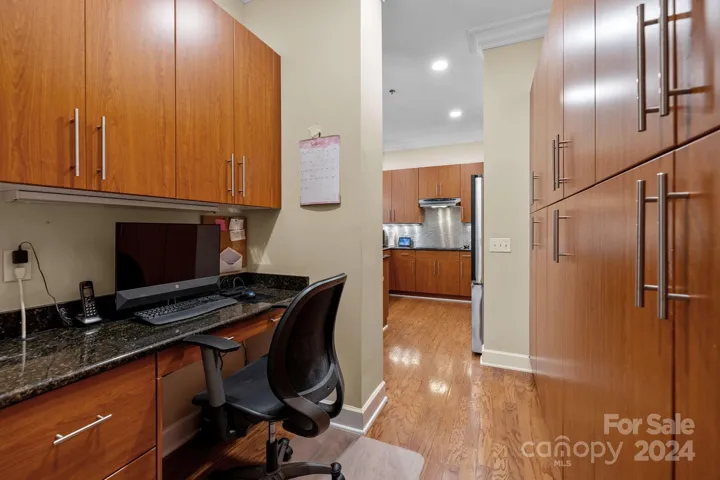 Office area tucked away behind the kitchen is a functional and convenient feature for today's multi-tasking lifestyle. This dedicated space is a perfect spot for managing household tasks, working from home, organizing schedules. Equipped with built-in desk and storage, it offers a clutter-free zone to handle paperwork, pay bills, check emails while staying close to the heart of the home.