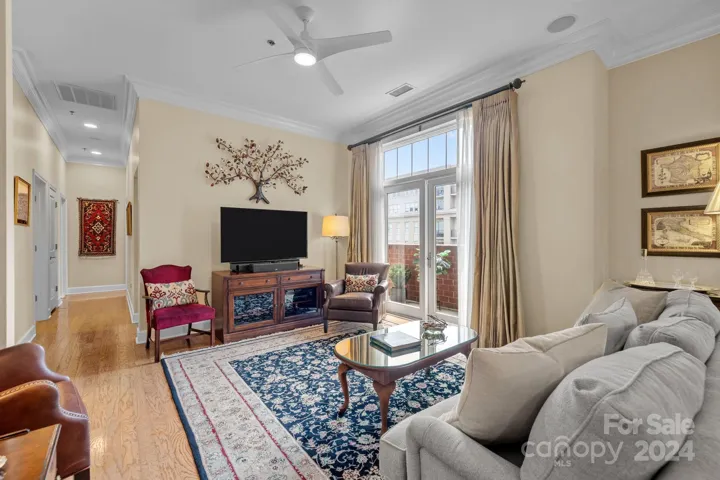 Large window/door with transom provide natural light. Neutral paint, designer ceiling fan, surround sound, wall space for a large screen TV.