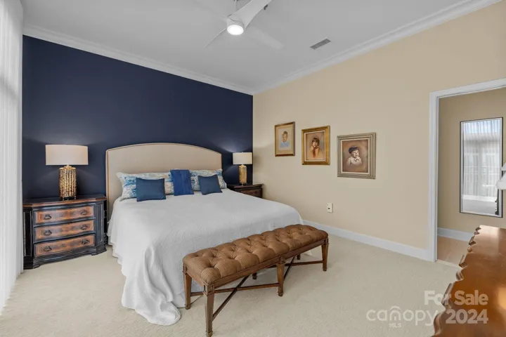 Owner's suite includes a large walk-in closet, en-suite bathroom, crown molding, ceiling fan with light, neutral carpet.