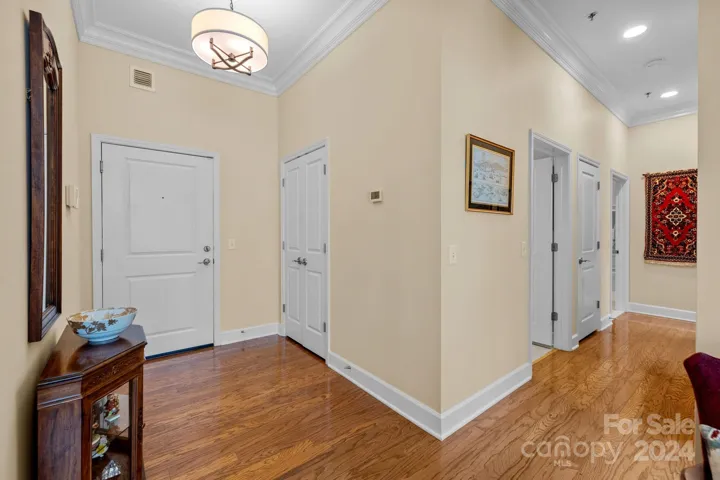 Gracious foyer provides a lovely introduction to this turn-key, move-in ready home with 10 foot ceilings throughout. Features crown molding, designer chandelier, coat closet, hardwood floors.