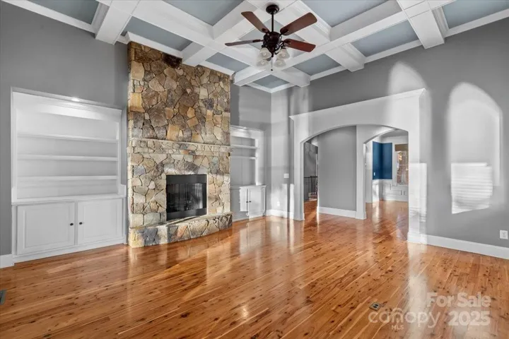 A coffered ceiling soars above the primary living room