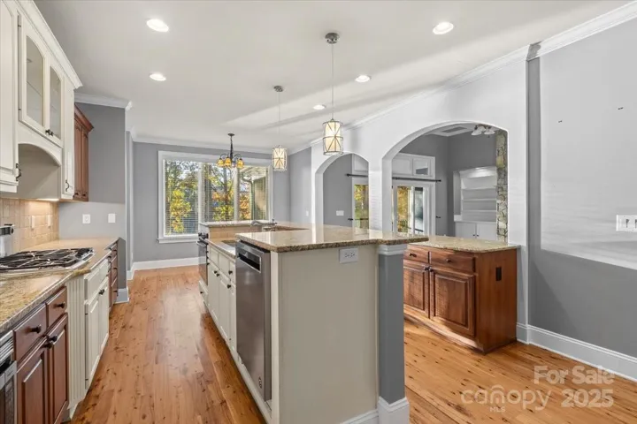 The primary kitchen overlooks the living rom and Lake Norman with the gorgeous dock just outside.