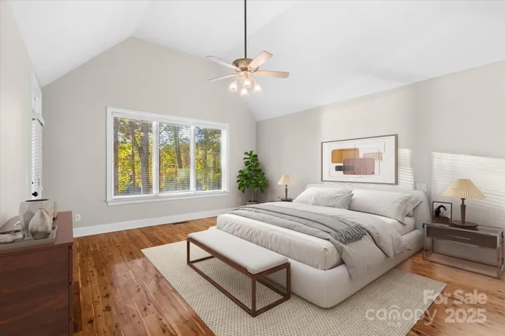 Virtually staged Primary Bedroom on main floor with soaring ceiling and stunning views to the waterfront and a priavte entrace to the upper screened room