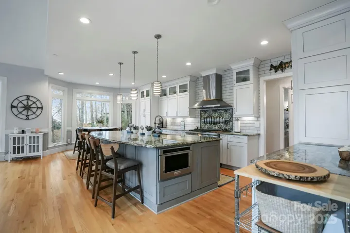 Freshly updated kitchen features a large kitchen island and custom cabinetry.