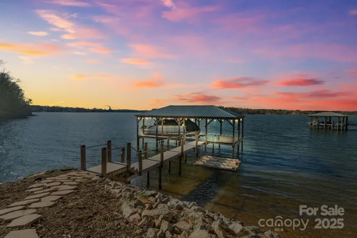 Private covered dock with boat lift and jet-ski ramps