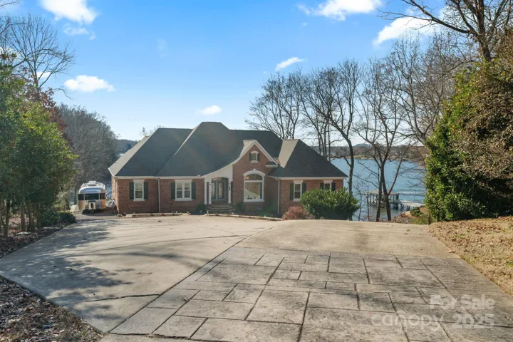 Expansive driveway with ample parking space for guests and RV/Trailer pad on side