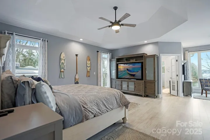 Primary suite with deck access and lake views.