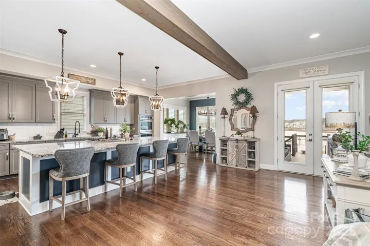 Open concept kitchen with gorgeous custom beams. The abundance of natural lighting provides an amazing ambience