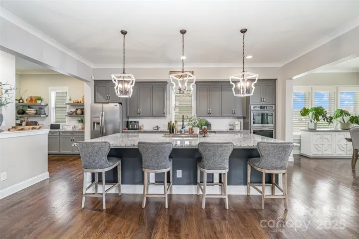 Massive kitchen island is a chef's dream. Ready to showcase homemade meals to guests