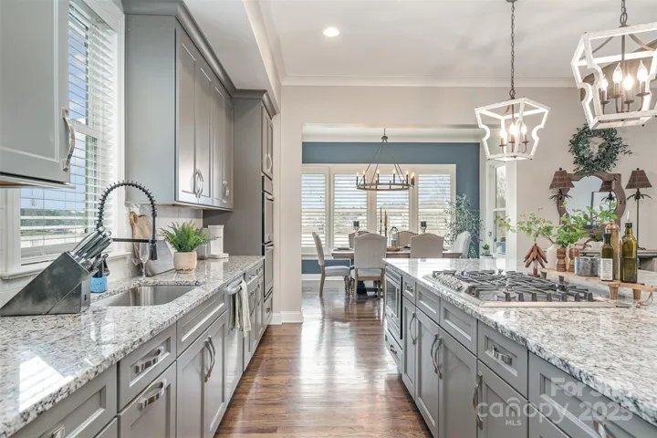 Open kitchen concept with gorgeous cabinetry and granite provides a sophisticated touch.