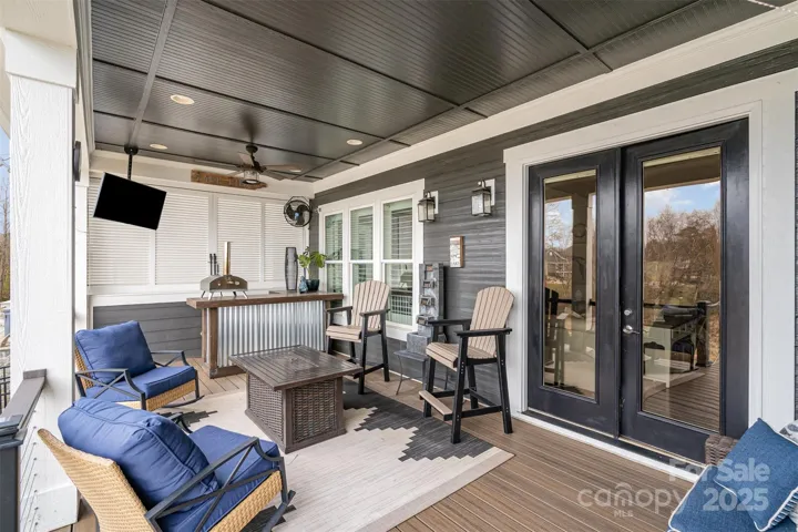 Oversized outdoor living space with custom kitchen and stunning lake views.