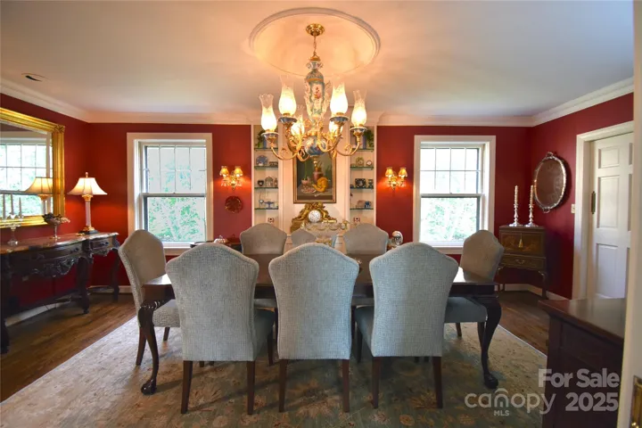 Large dining room with east facing windows look onto the Sunset Mountain hillside.
