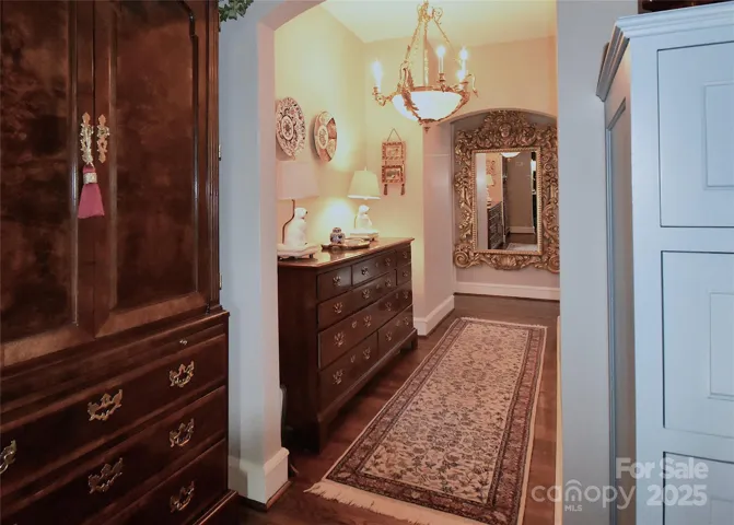 Central corridor in B9 leads to dressing room and full bath that occupy the primary suite.