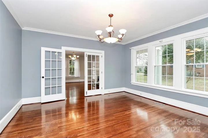 Formal dining room with gorgeous hardwoods, natural light and French doors.