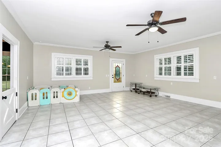 Huge family/bonus room on the main level with a Dutch door to the kitchen and a stained-glass door to the exterior.