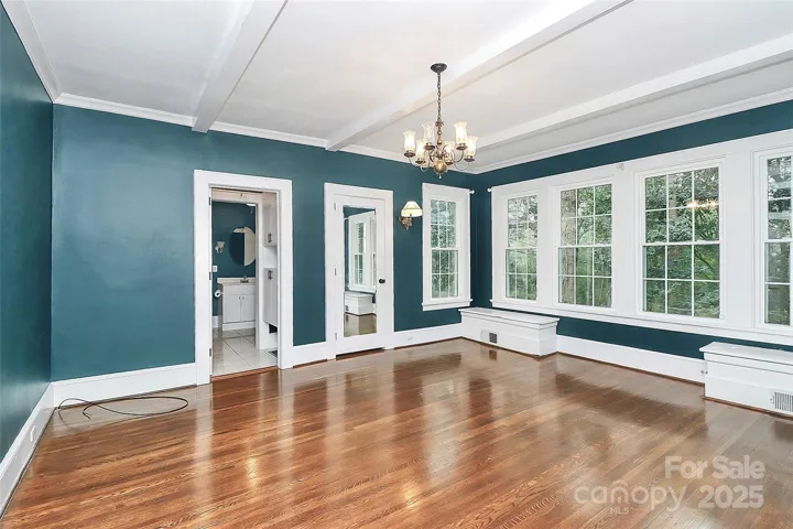 Primary bedroom on the main floor with an attached full bathroom. Tons of natural light and storage.