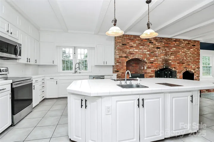 Kitchen has 2 sinks, 2 disposals and 2 electric cook tops.