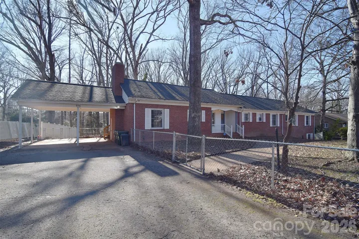 Fully Fenced yard with 2 car carport