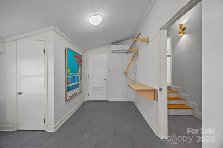 Laundry/Utility Room with Side by Side Washer and Dryer that conveys.  LOTS of SHELVING too!