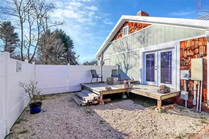 Back deck with French doors from primary bedroom