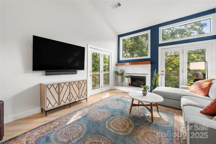 main living room with fireplace and views of the lake