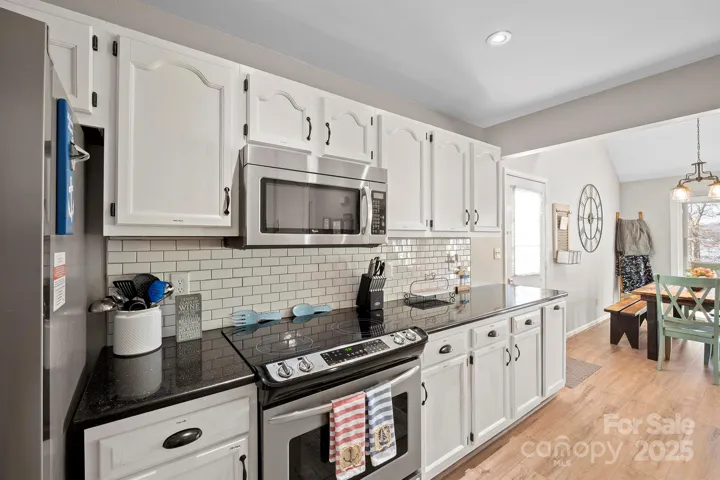 Bright, Upgraded Kitchen features granite counters, stainless steel appliances including Refrigerator to remain, tile back splash, plenty of cabinets for storage, pantry & Dining Area!