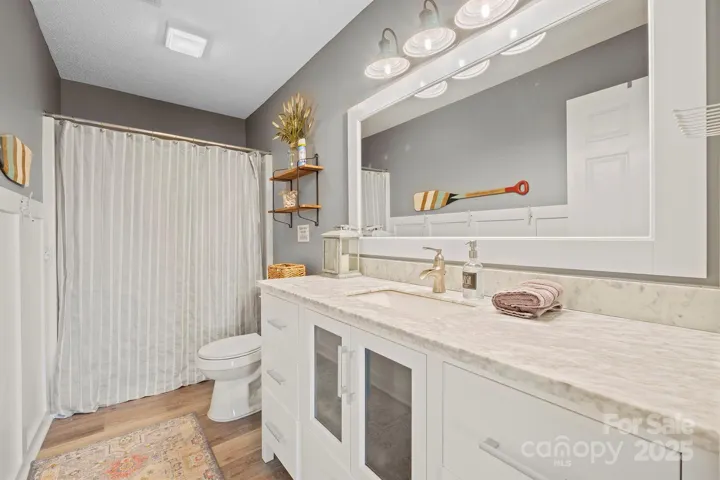 Primary Bath features tub/shower, custom molding & lighting & LVP floors!