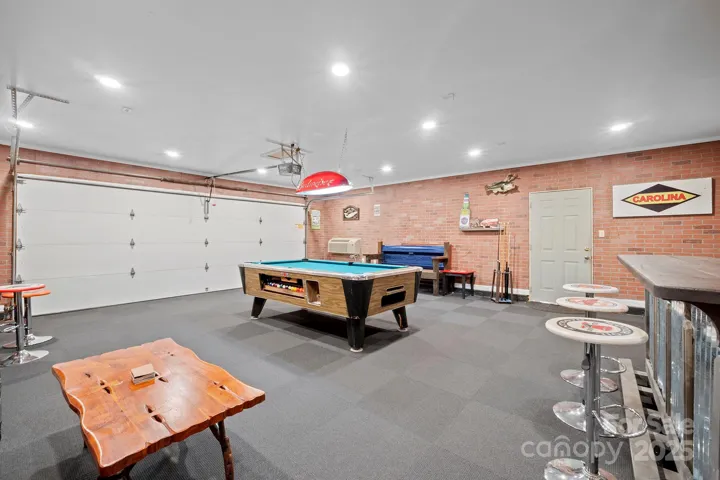 Garage converted into Game/Recreation Room with new carpet, lighting, bar area, pool table to remain & separate, mini split HVAC unit!