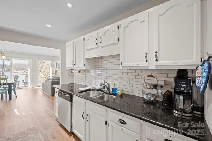 Bright, Upgraded Kitchen features granite counters, stainless steel appliances including Refrigerator to remain, tile back splash, plenty of cabinets for storage, pantry & Dining Area!