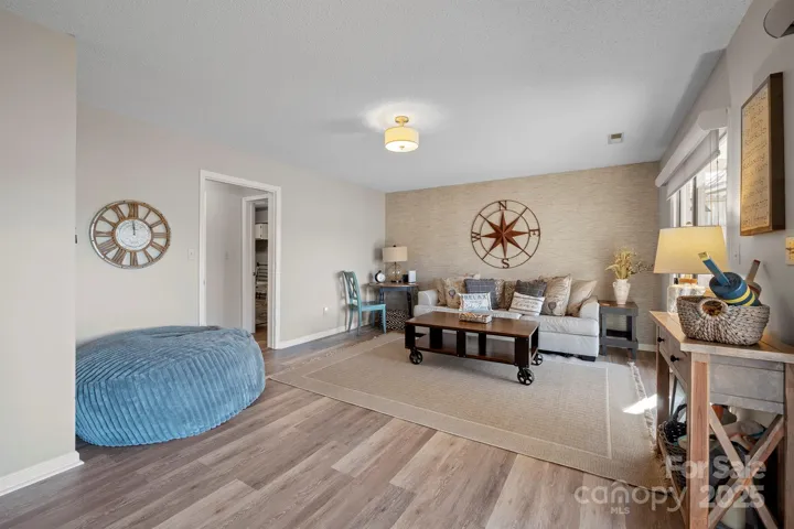 Basement Level Living Room with LVP floors & walk out access to covered patio with Amazing Lake Views!