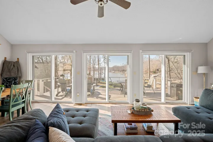 Vaulted Living Room with deck access & tons of natural light, LVP floors & fabulous Water Views!