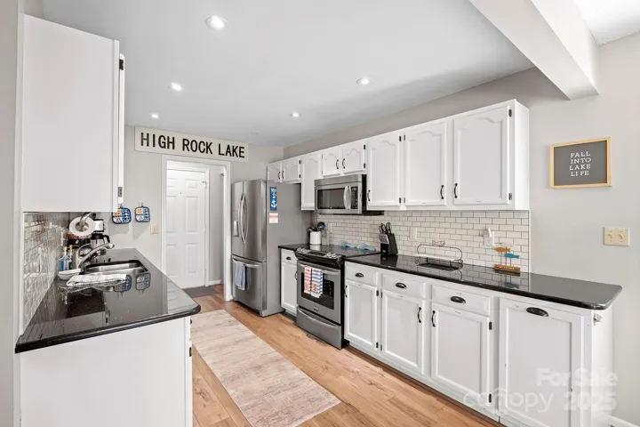 Bright, Upgraded Kitchen features granite counters, stainless steel appliances including Refrigerator to remain, tile back splash, plenty of cabinets for storage, pantry & Dining Area!