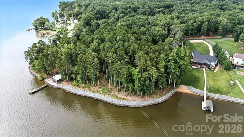 Waterfront lot begins just to the left of the home on the right.