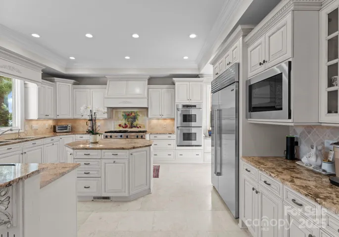 Expansive counter space is provided by both the island and peninsula, ideal for meal prep and entertaining.