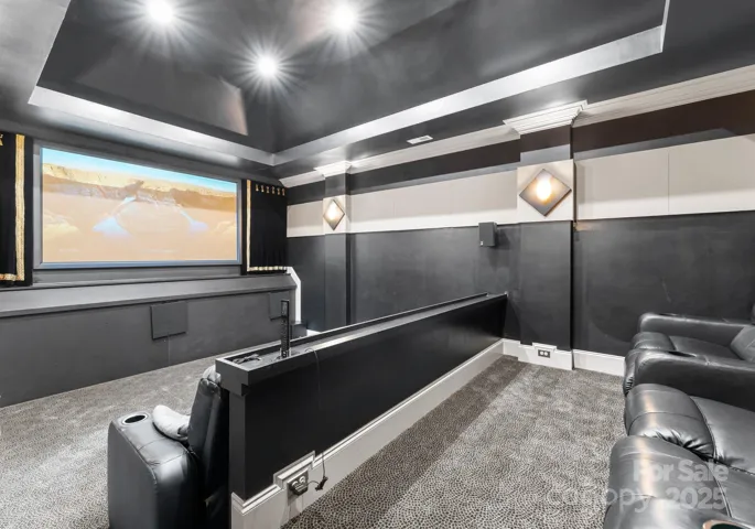 The lake level theater room is a luxurious, dedicated space for movie nights, featuring plush seating, ambient lighting, and high-end sound and projection systems. Designed for the ultimate cinematic experience, this room offers an immersive environment that rivals any professional theater.