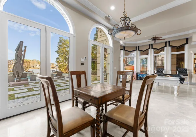 The expansive lake level boasts a cozy fireplace, a refined billiard area, and an inviting sitting space, creating the perfect blend of relaxation and entertainment.