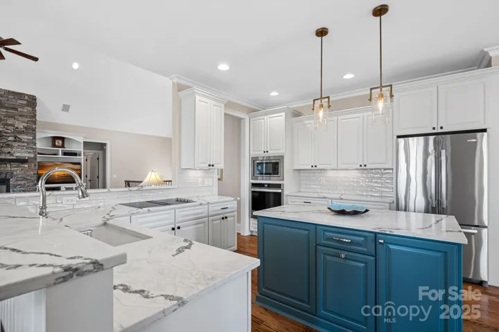 Newly renovated gourmet kitchen with SS appliances, quartz countertops, large island, and breakfast bar....open to the dining and living areas with lake views!